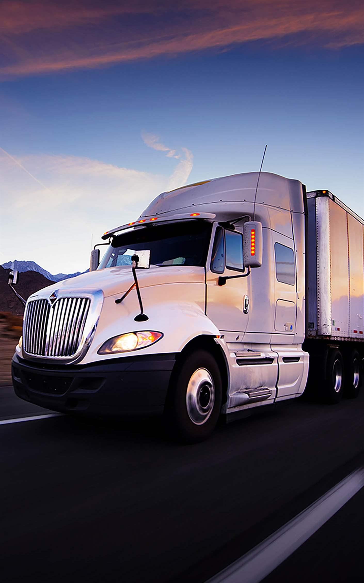Truck and highway at sunset - transportation background