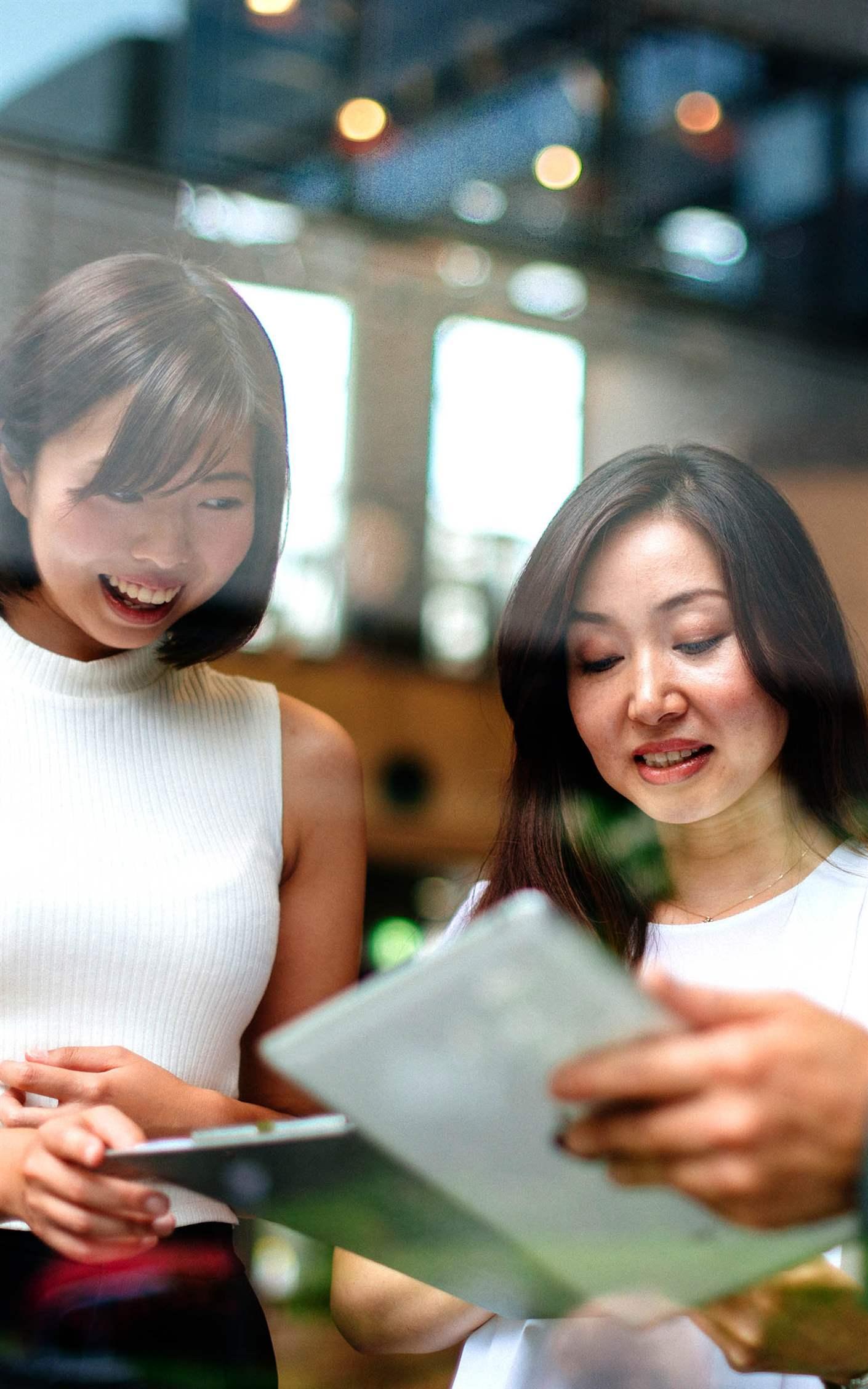 Three Japanese business people in modern office building